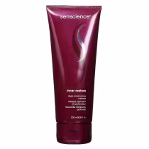 A imagem mostra a embalagem em tubo plástico flexível de cor vinho. Rótulo com o nome do produto "inner restore" e descrição da máscara capilar.