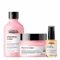 Três produtos de cuidados capilares da linha L'Oréal Professionnel Série Expert. O primeiro é um shampoo Vitamino Color em um frasco rosa. O segundo é uma máscara de tratamento Vitamino Color. O terceiro é um óleo de reparação Absolut Repair Oil.