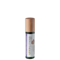 Embalagem cilíndrica de vidro verde escuro com tampa de madeira clara. Rótulo branco com texto "Pure Absolut Therapy" e imagem de flores rosas. Tamanho compacto e portátil para aplicação de fragrância natural.