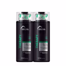 A imagem mostra dois frascos de shampoo da linha Therapy da Truss. Os frascos são pretos com detalhes em verde e branco, e têm folhas estampadas na parte superior transparente.