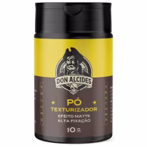 Frasco preto e amarelo de 10g contendo pó texturizador da marca Don Alcides, com efeito matte e alta fixação, conforme indicado no rótulo do produto.