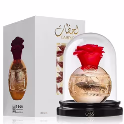 Frasco de perfume Lattafa Lahdath com design dourado e vermelho, contido em uma caixa branca com detalhes dourados. O frasco possui um formato arredondado e uma tampa vermelha em forma de flor.