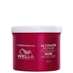 É um condicionador para cabelos da marca Wella Professionals. O produto vem em uma embalagem vermelha com tampa branca. A embalagem tem capacidade de 500ml. O rótulo indica que é o "Ultimate Repair Passo 2", um condicionador para reparar e hidratar.