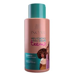 A imagem mostra o Shampoo Inoar Meu Cacho Meu Crush Teen 500ml em embalagem cilíndrica de plástico, com tons de rosa, roxo e verde. Traz ilustração de meninas com cabelos cacheados. O rótulo exibe a descrição Shampoo - Fórmula suave e Hidratação Profunda.