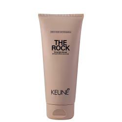 A imagem mostra o Gel de Cabelo The Rock da marca Keune. O produto vem em um tubo plástico na cor bege claro. Na parte superior está impresso em letras pretas "THE ROCK Strong high-shine gel".