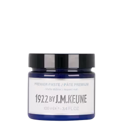 Pasta modeladora da marca Keune, com design moderno e rótulo branco com texto preto. Contém 100 ml do produto "Premier Paste" com acabamento fosco, conforme indicado na embalagem.