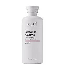 Frasco branco da linha Absolute Volume da Keune, contendo shampoo amplificador de volume com extrato de lírio. Embalagem cilíndrica com tampa e rótulo preto e branco destacando o nome do produto.