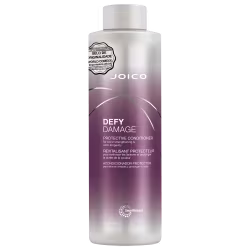 Frasco do condicionador Joico Defy Damage de 1 Litro, com rótulo em tons de roxo e rosa, indicando ser um produto protetor para fortalecimento e prolongamento da cor do cabelo.