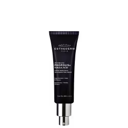 Tubo preto da marca Institut Esthederm Paris contendo o produto "Intensive Propolis+ Ferulic Acid", um creme perfeccionador de pele. O rótulo destaca os benefícios do produto, como redução de imperfeições, rugas e brilho.