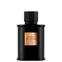Frasco preto fosco com tampa cilíndrica preta. Rótulo retangular dourado com o nome "David Beckham Bold Instinct" em letras pretas. Design minimalista e elegante, com formas geométricas limpas. Embalagem sofisticada e moderna.