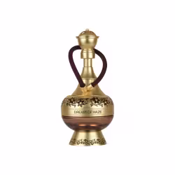 Frasco de perfume dourado com detalhes florais em relevo, contendo o nome "Dream of Haze" em sua base. O frasco possui um design elegante e retrátil, com um cordão marrom escuro.