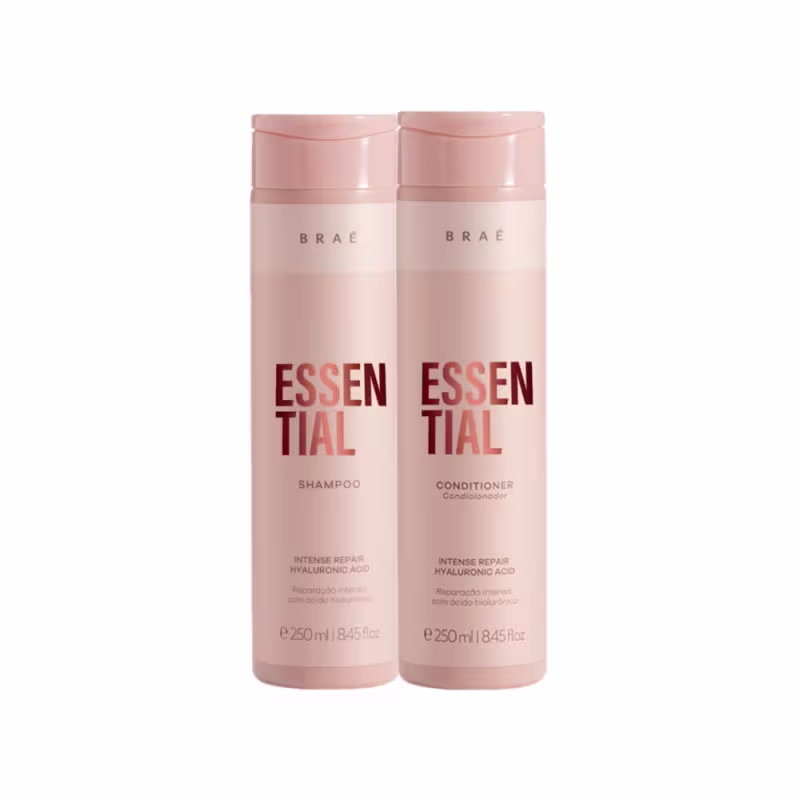 Frascos de shampoo e condicionador da linha Essential da marca Braé, com embalagens rosadas e rótulos em vermelho destacando os ingredientes de reparo intenso e ácido hialurônico.
