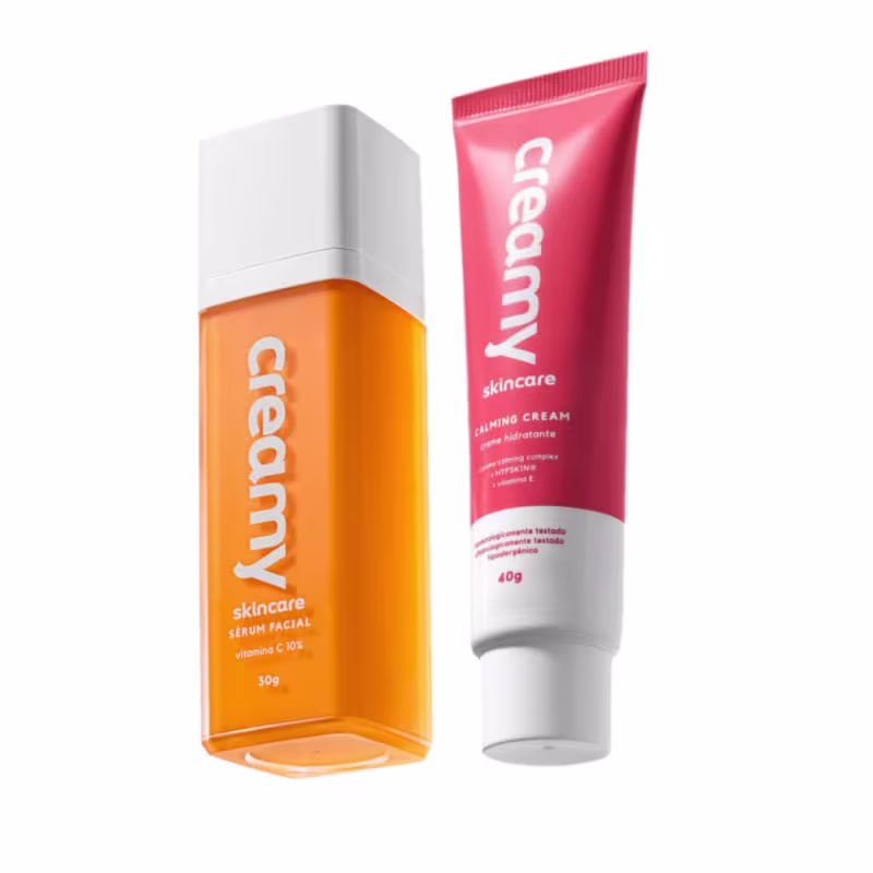 Dois produtos de cuidados com a pele da marca Creamy: um frasco laranja contendo sérum facial Vitamina C e um tubo vermelho com Calming Cream.