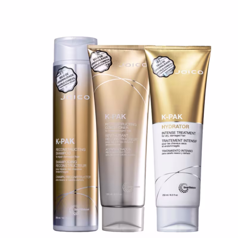 A imagem mostra shampoo de 300ml, condicionador de 250ml e máscara de 250ml da linha K-PAK da marca Joico. As cores predominantes são branco, dourado e prata.
