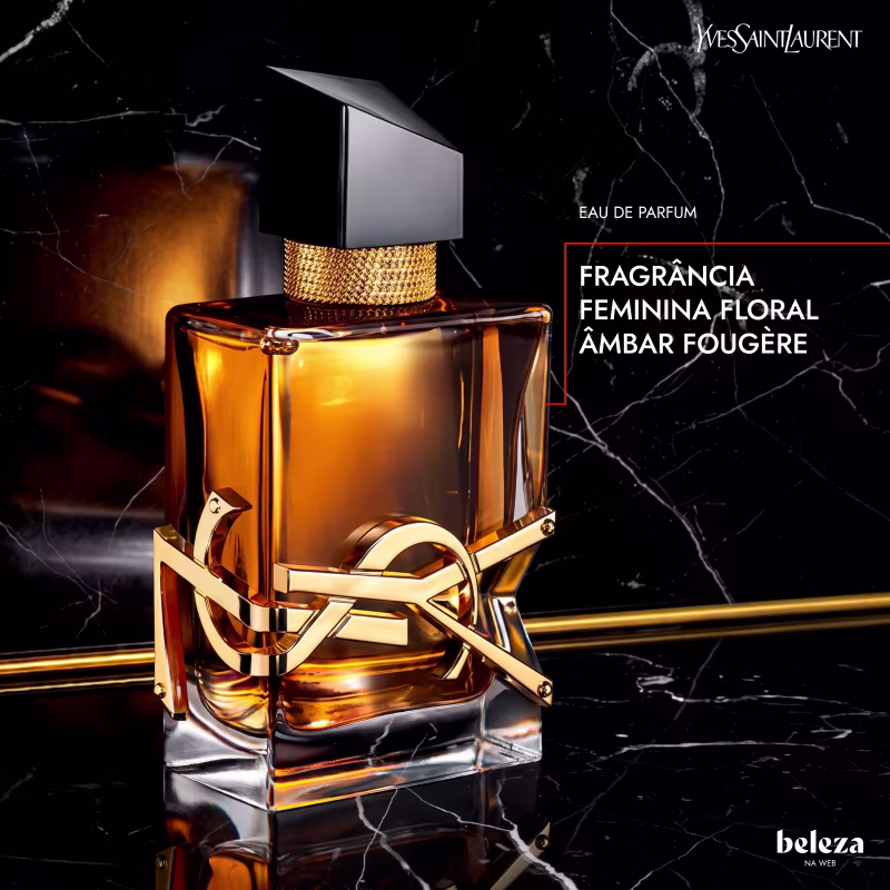 Frasco de perfume Yves Saint Laurent com design elegante em preto e dourado. Recipiente de vidro transparente contendo líquido âmbar, com tampa e detalhes metálicos dourados. Rótulo com logotipo da marca em destaque.
