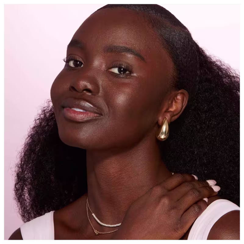 A imagem mostra o rosto de uma mulher usando a base líquida.