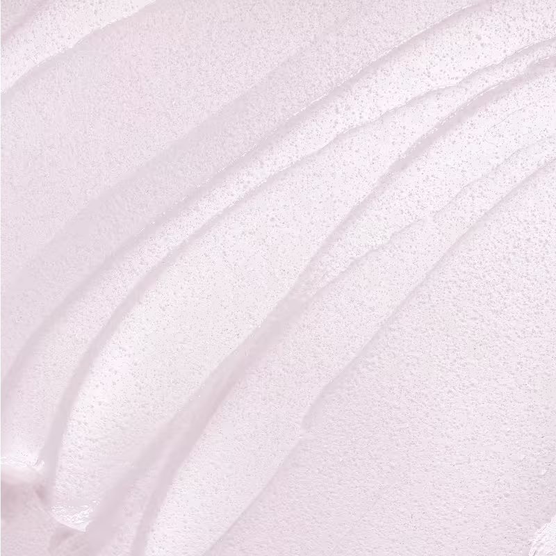 A imagem mostra uma textura muito delicada e sedosa que parece ser um produto de maquiagem da marca Wet n Wild. Trata-se de um close em um tom suave e acetinado de primer facial.