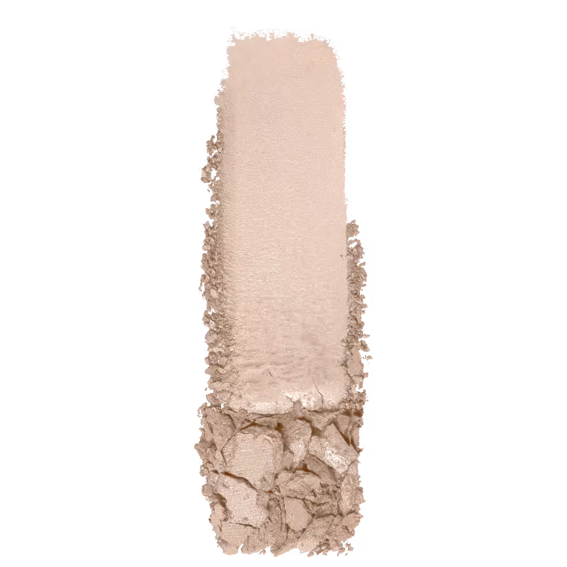 A imagem mostra uma amostra de sombra nude, da marca Wet n Wild. O produto está depositado em uma superfície branca, a fim de mostrar a sua textura e acabamento.