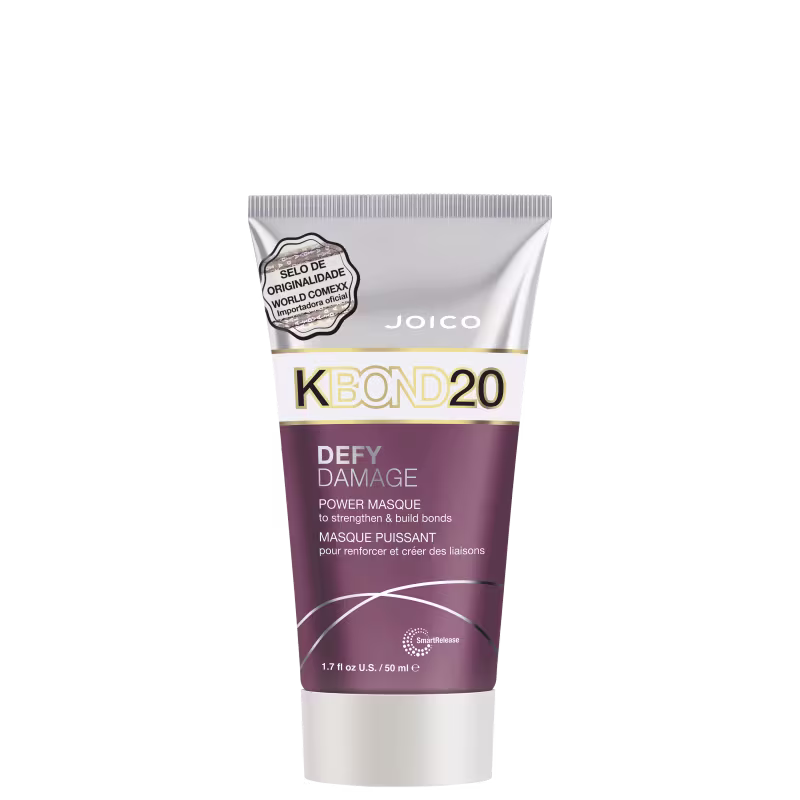 A embalagem é um tubo plástico roxo, branco e prateado com detalhes em dourado. O rótulo frontal apresenta o nome do produto e informações como "para fortalecer e criar ligações".