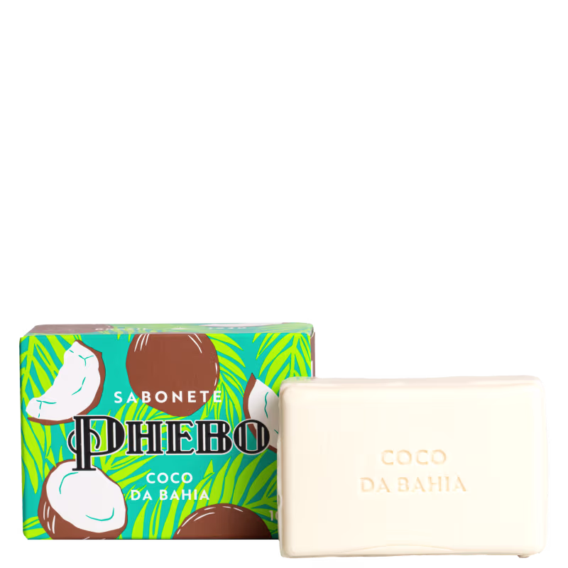 Sabonete em barra. A embalagem é uma caixa retangular com fundo turquesa e detalhes em verde limão e marrom, apresentando ilustrações de coco e um pássaro branco. O sabonete é uma barra retangular branca com o texto "Coco da Bahia" gravado na superfície.