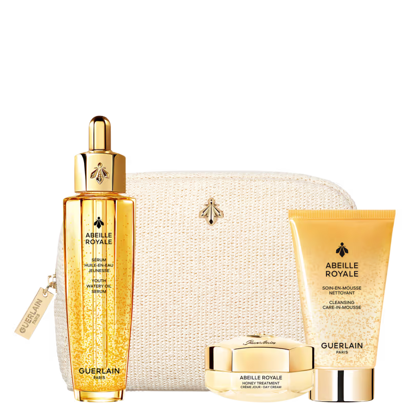 GUERLAIN KIT COM ABEILLE ROYALE SERUM OLEO REJUVENESCEDOR 50ML, ABEILLE ROYALE CREME DIA MINI 15ML E ABEILLE ROYALE ESPUMA DE LIMPEZA MINI 40ML. NÉCESSAIRE BEGE AO FUNDO