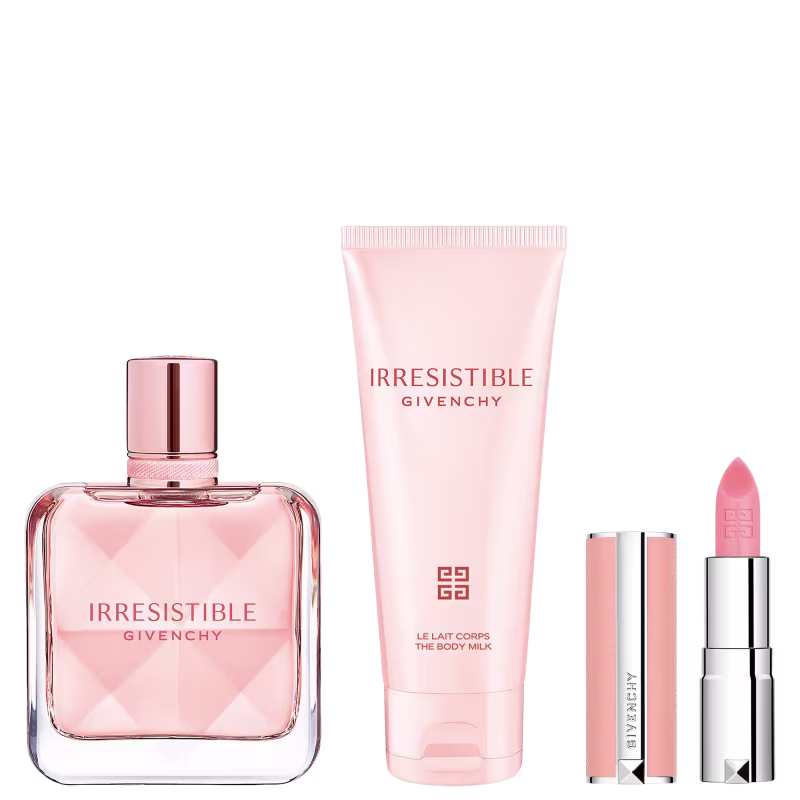 Conjunto de produtos de beleza da marca Givenchy, incluindo um frasco de perfume Irresistible, um tubo de creme corporal e um batom rosa, todos embalados em uma caixa decorada com flores em tons de rosa e prateado.