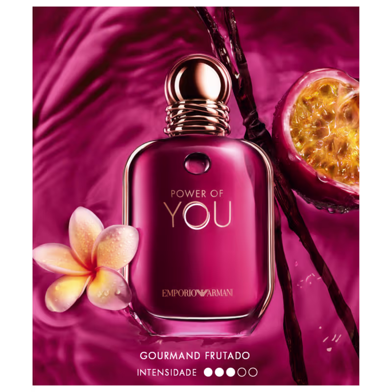 Item de perfumaria em frasco de vidro com tampa dourada, em tom de rosa escuro, com texto "POWER OF YOU" e "EMPORIO ARMANI" em dourado. Acompanhado de flor amarela e laranja. Fundo rosa intenso.