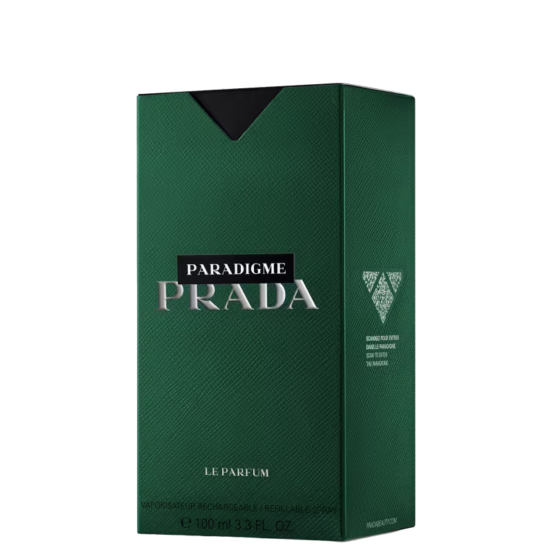 Caixa verde escura com o logotipo da Prada em branco e prata, contendo um frasco de perfume Paradigme da marca. A embalagem apresenta uma textura de couro sintético e o rótulo indica que se trata de um "Le Parfum" com 100 ml de conteúdo.