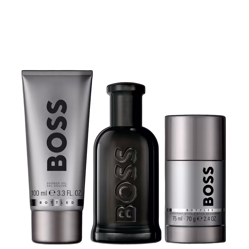 Três produtos de beleza da marca Boss: um frasco de gel de banho, uma garrafa de perfume e um desodorante, todos em tons de preto e cinza com o logotipo da marca destacado.