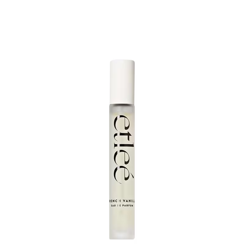Frasco de perfume Etleé com design minimalista em branco e preto. Rótulo em destaque com o nome da fragrância "French Vanilla". Embalagem cilíndrica com tampa branca, transmitindo elegância e sofisticação.