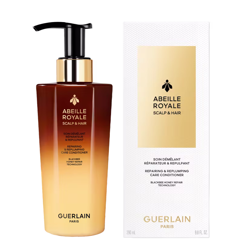 Frasco de condicionador capilar da linha Abeille Royale da Guerlain, com embalagem em tons de marrom e dourado. O produto é descrito como um tratamento reparador e reforçador para o couro cabeludo e cabelos.