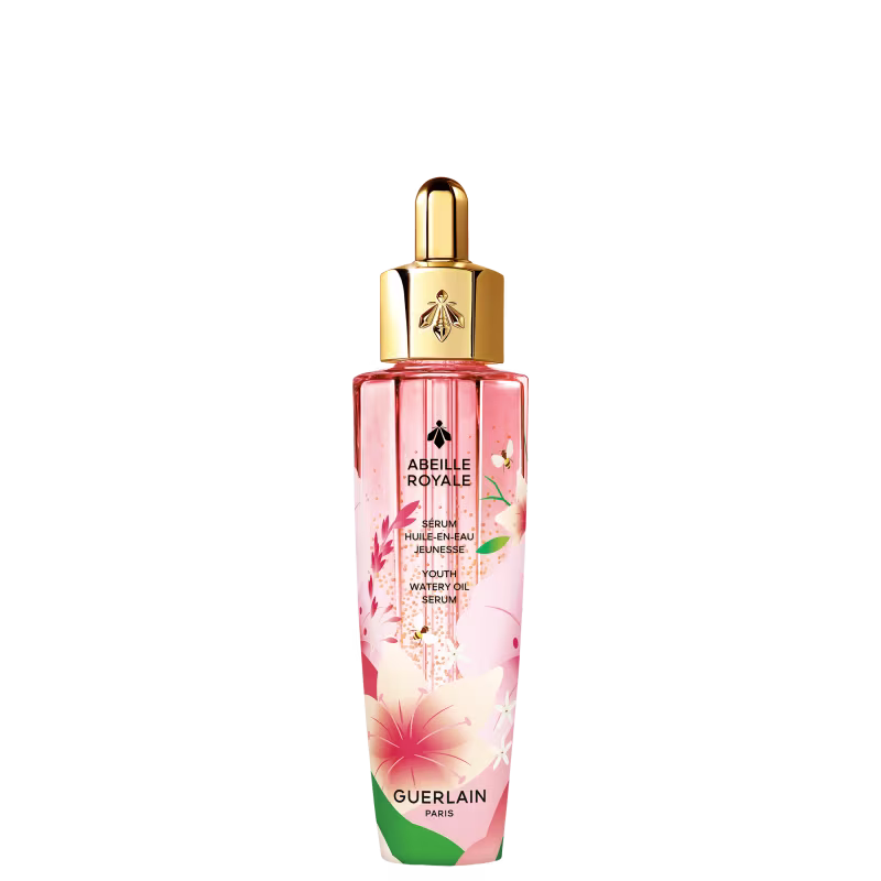 Frasco de vidro rosa com tampa dourada contendo o sérum "Abeille Royale" da Guerlain, com detalhes florais e texto em francês descrevendo o produto como um sérum de óleo aquoso para juventude.