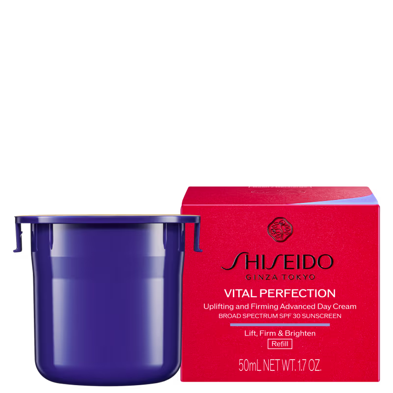 Caixa vermelha e frasco azul refil da linha Vital Perfection da Shiseido, contendo um creme facial de dia com FPS 30 e promessas de firmeza e luminosidade.