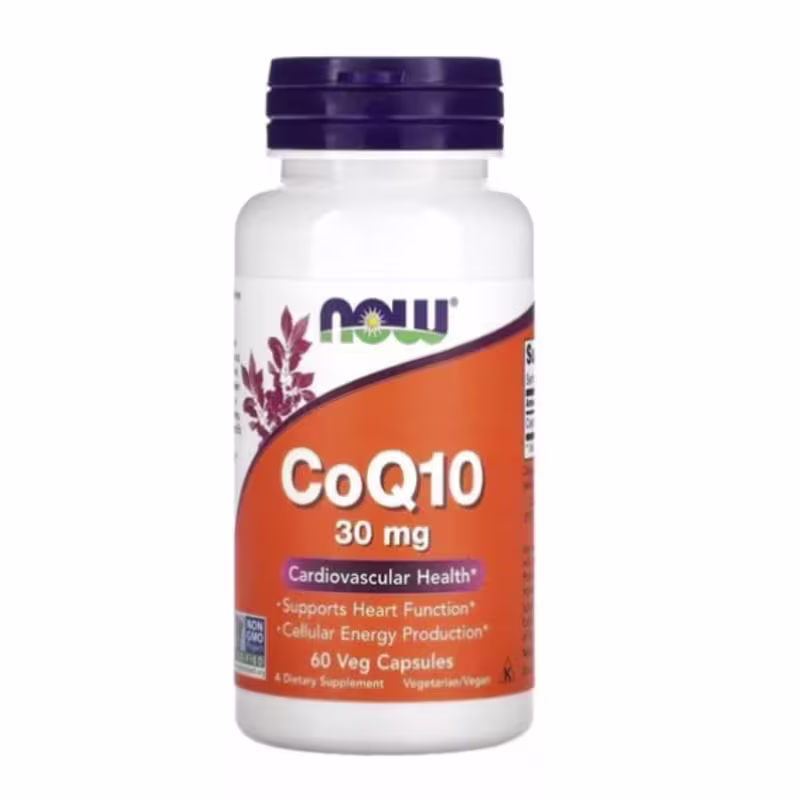 O produto mostrado é um suplemento alimentar da marca Now Foods. É uma embalagem plástica branca com uma tampa roxa. O rótulo laranja destaca "CoQ10 30mg" e menciona que é para "Saúde Cardiovascular", "Função Cardíaca" e "Produção de Energia Celular".