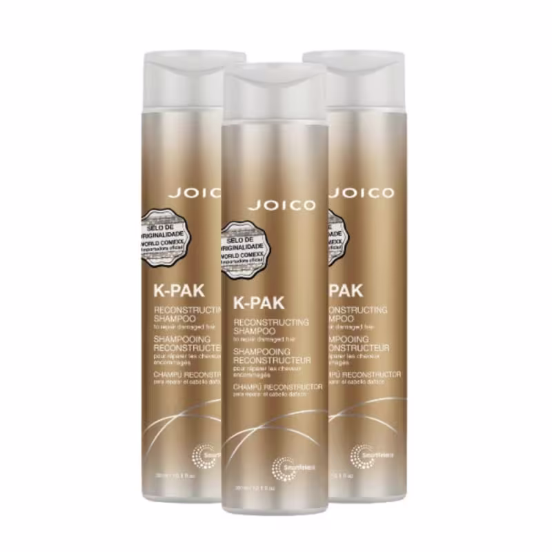 Três frascos de shampoo reconstrutor K-PAK da marca Joico, com embalagem em tons de dourado e branco, exibindo o logotipo da marca e informações sobre o produto.