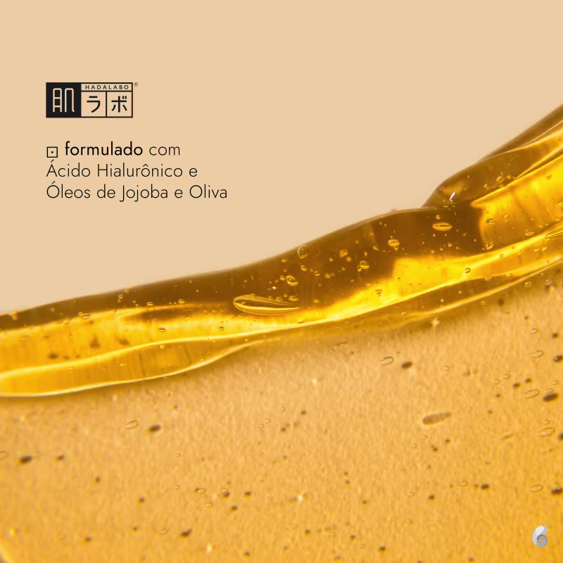 Zoom no líquido dourado do produto. Textura oleosa com bolhas. Texto em português indicando que é formulado com Ácido Hialurônico e Óleos de Jojoba e Oliva.