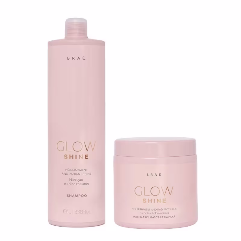 Dois produtos da marca Braé: um frasco de shampoo rosa claro com rótulo "Glow Shine" e um pote rosa claro com rótulo "Glow Shine Hair Mask", ambos com acabamento brilhante e textos em dourado.