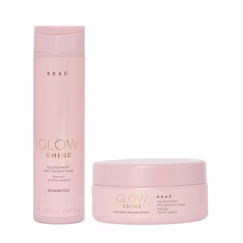 O conjunto de produtos Braé Glow Shine inclui um frasco de shampoo rosa e um pote de máscara capilar rosa, ambos com rótulos destacando os benefícios de nutrição e brilho radiante.