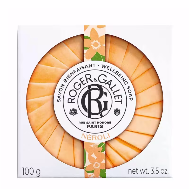 Sabonete em barra da marca Roger & Gallet, com embalagem circular em tons de laranja e branco, exibindo o logotipo da marca e a fragrância "Néroli". O produto possui 100g e é apresentado em uma caixa com informações sobre a marca e o produto.