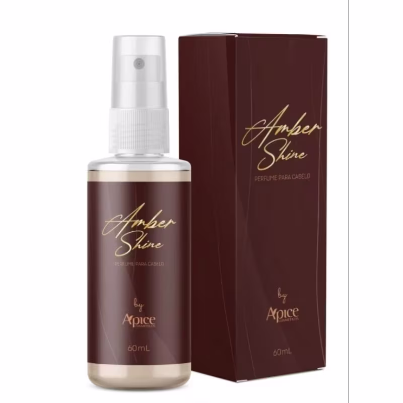 Perfume capilar da marca Apice Cosméticos, chamado "Amber Shine". O frasco é de vidro transparente com um borrifador, e a embalagem é uma caixa de papelão marrom com o nome do produto em dourado.