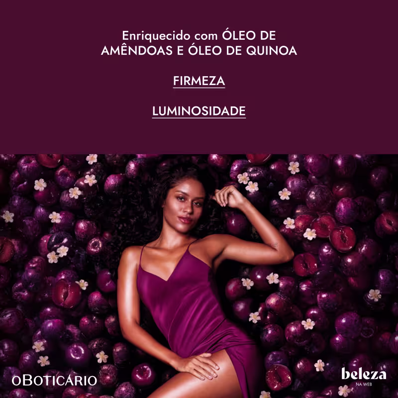 Uma mulher de cabelos escuros e cacheados em um vestido roxo está rodeada por ameixas roxas e flores brancas em um fundo escuro. O texto visível diz "Enriquecido com óleo de amêndoas e óleo de quinoa. Firmeza. Luminosidade."