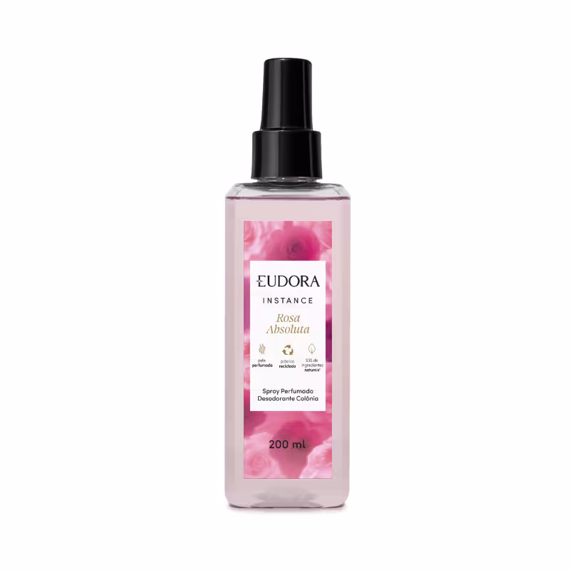 O produto apresentado é um spray perfumado desodorante da linha Instance Rosa Absoluta. O frasco é de plástico transparente com um rótulo rosa, destacando informações sobre o produto. Possui um design elegante e minimalista, com uma tampa preta.