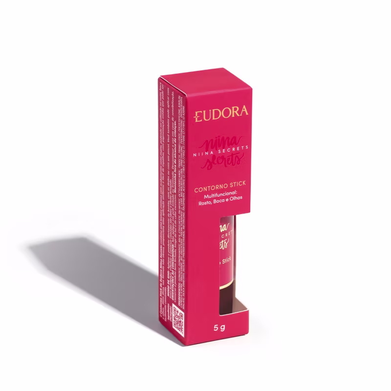 A embalagem do Contorno Stick é uma caixa rosa com o nome da marca e da linha impressos em dourado. O produto em si é um bastão de maquiagem com uma tampa protetora.