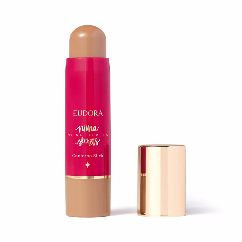 O produto apresentado é um contorno em bastão da linha Niina Secrets. A embalagem é cilíndrica e de cor rosa vibrante, com o nome da marca e da linha impressos em letras douradas. A embalagem também possui um detalhe dourado na parte superior.