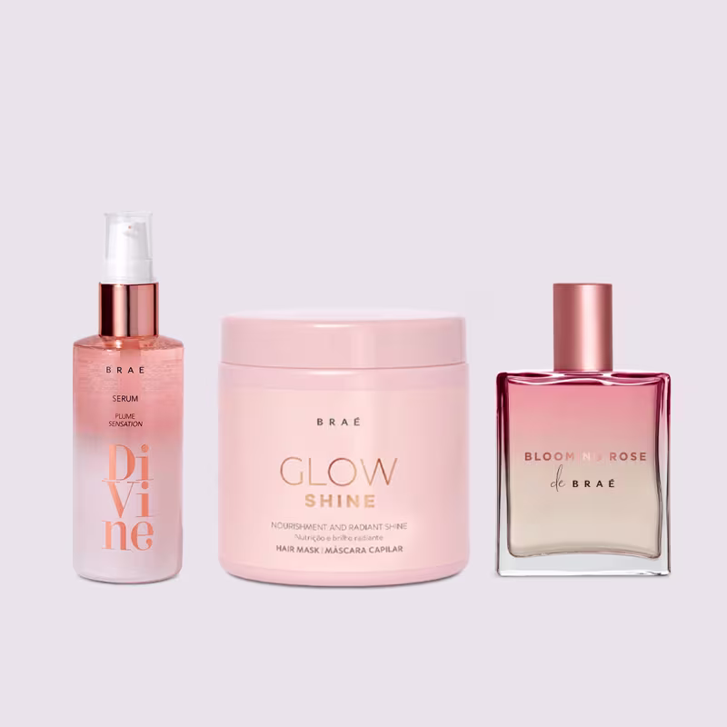 A imagem mostra três produtos da marca Brae: sérum Divine Plume, máscara Glow Shine e perfume capilar Blooming Rose. As cores predominantes são rosa claro e dourado.