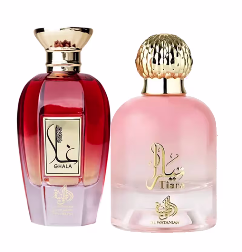 Dois frascos de perfumes Al Wataniah: um vermelho com rótulo "Ghala" e outro rosa com rótulo "Tiara". Ambos possuem tampas decorativas douradas e apresentam design elegante e sofisticado.