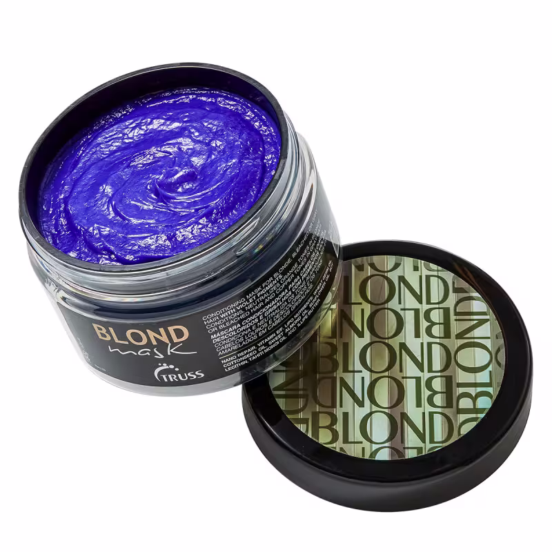 A imagem mostra o pote da máscara aberto, permitindo ver a cor violeta do produto.