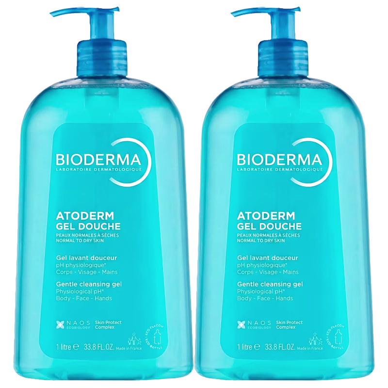 Dois frascos de gel de banho Bioderma Atoderm, com embalagem azul-turquesa e rótulo branco, contendo 1 litro cada. O produto é indicado para peles normais a secas.