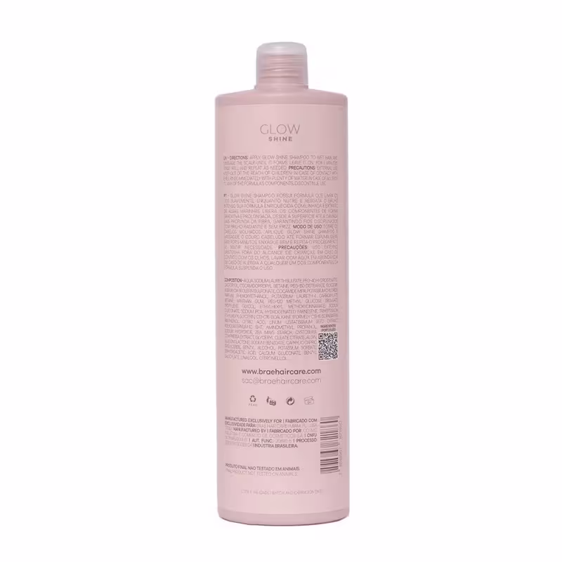 Shampoo Glow Shine da marca Brae. Embalagem na cor rosa claro. Rótulo com texto descritivo em português e inglês, detalhando instruções de uso, ingredientes e informações do fabricante. Formato cilíndrico com tampa rosqueada na parte superior.