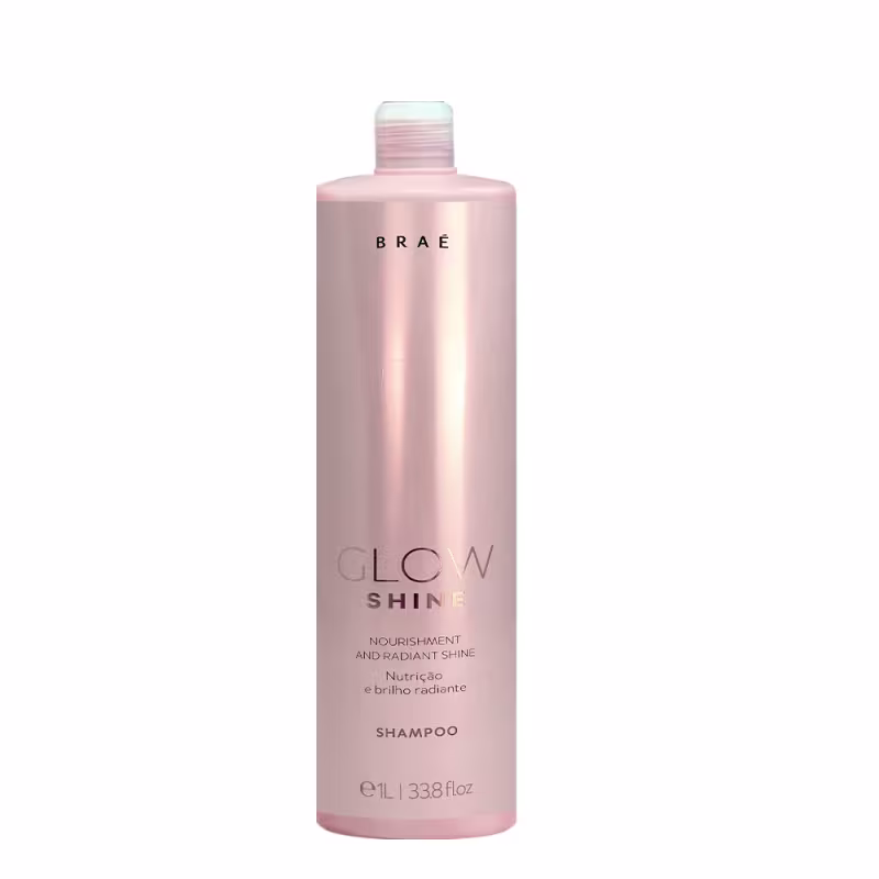 Shampoo Glow Shine da marca Braé. Embalagem plástica cilíndrica rosa claro perolado. Rótulo preto com o nome da marca "BRAÉ" em letras maiúsculas e "GLOW SHINE" abaixo em letras menores.